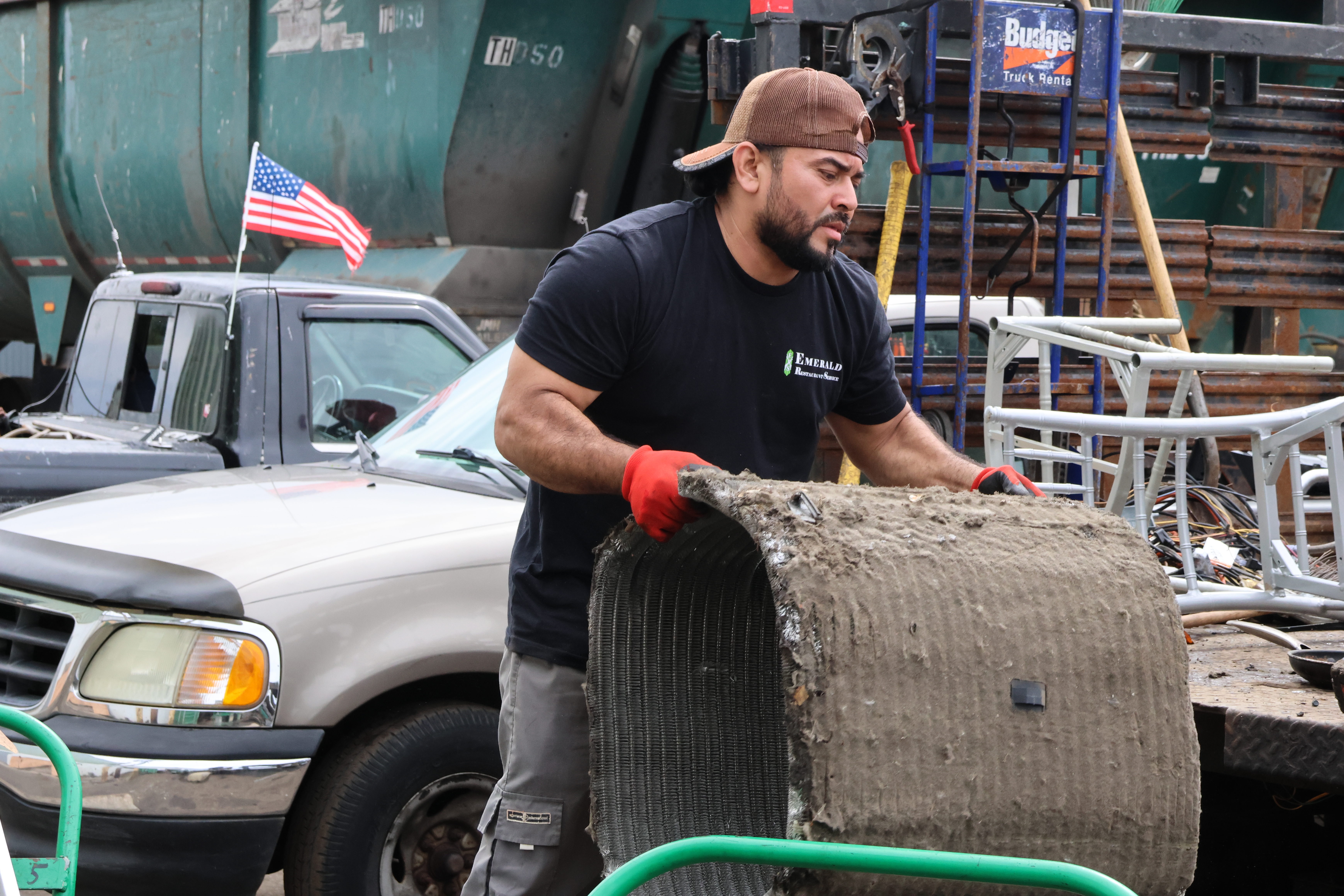 Juarez lugs another large piece of scrap metal from one cart to another. Juarez runs his own Youtube channel (@chapin4kjc467) where he shows pieces of his life: scrapping metal and other things people throw away, finding work in the US and Chicago and beautiful places in and around the city.