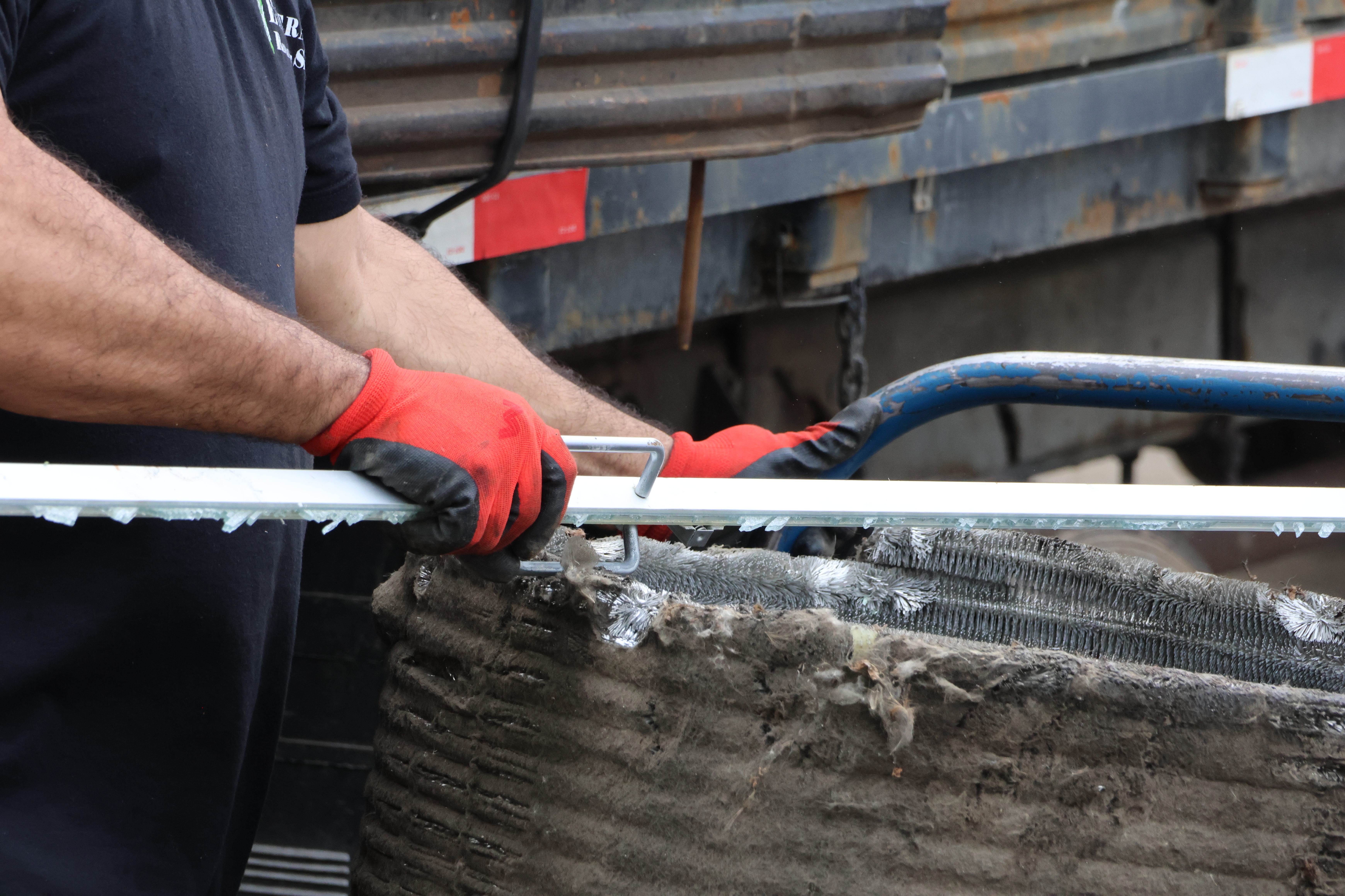 Juarez maneuvers a shattered glass door onto the cart. He said, for work, he does a bit of everything. "Work is work, man," he said. "Everyone around here, man, they work."
